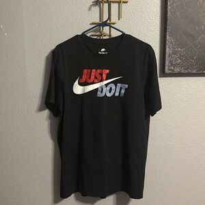 Nike black tee. “Just do it” in red and blue.